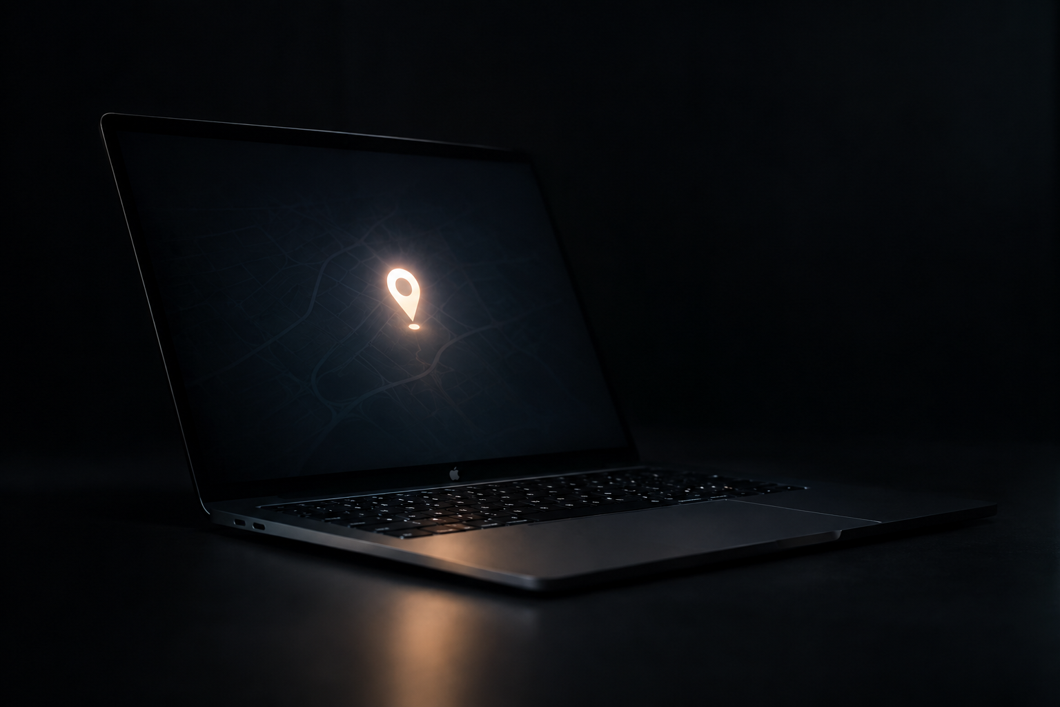 Close-up of a laptop keyboard corner and power key in low, moody lighting